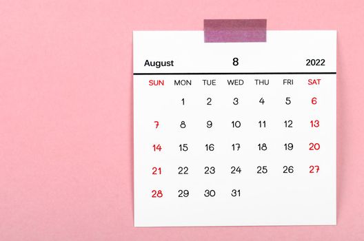 The August 2022 calendar on pink background.