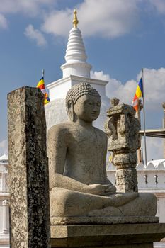 Sri Lanka. Anuradhapura. Thuparamaya Stupa is the earliest Dagoba to be constructed in the island. A statue of a sitting Buddha. High quality photo