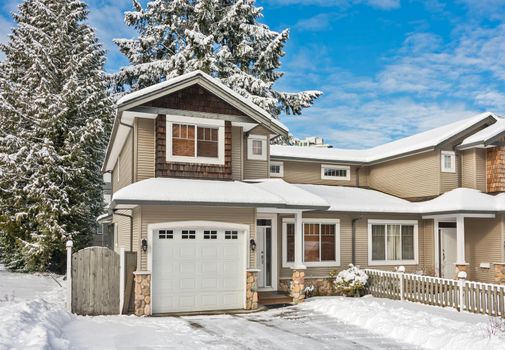 Entrance of residential duplex house with driveway in snow. Winter season in Canada