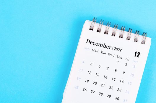 The mini December 2022 desk calendar on blue background.
