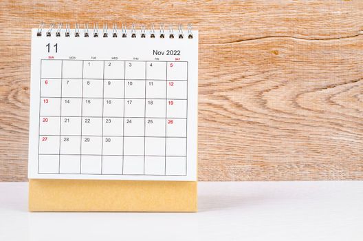The September 2022 desk calendar on wooden table.