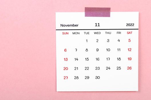 The November 2022 calendar on pink background.