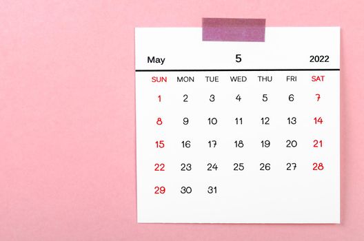 The May 2022 calendar on pink background.