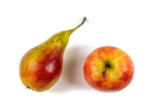 Apple and pear side by side on a cropped white background