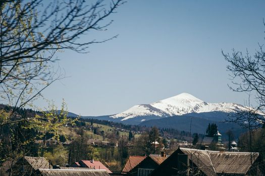 Snow-capped mountain on the horizon, and mountain villages. High quality photo