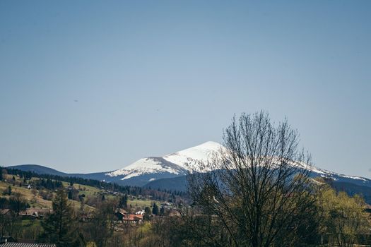 Snow-capped mountain on the horizon, and mountain villages. High quality photo