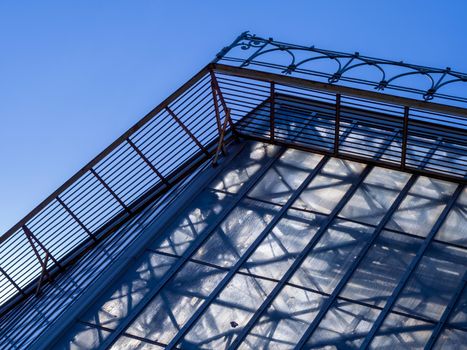 Building facade with blue sky. Glass wall in modern architecture.