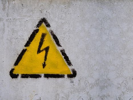 Zipper sign in the yellow triangle on the common wall. dangerously high voltage.