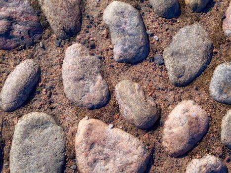 Historic cobblestone pavement, top view, stone road texture