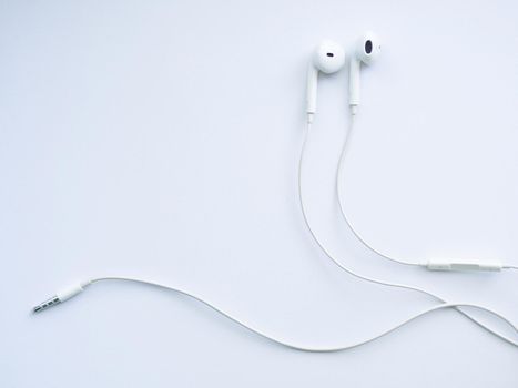White wired headphones, headset on a white background. Musical day