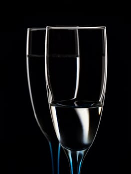 Elegant picture of glasses with clear water on a black background