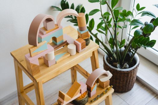 Children's constructor made of natural material. Abstract construction of wooden cubes. No plastic toys. Zero waste. Environmentally friendly materials in the production of toys for children.