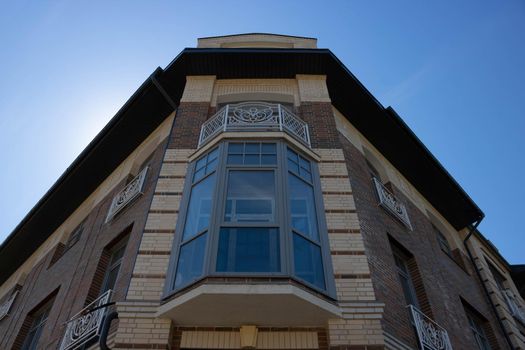 A new house with a glazed balcony against the sky. On the streets, in public places