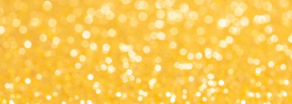 sparkles of yellow glitter abstract background. Copy space. Banner