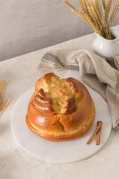 Fogaça on kitchen countertop with eggs and cinammon sticks. Traditional cake from Santa Maria da Feira, Portugal.