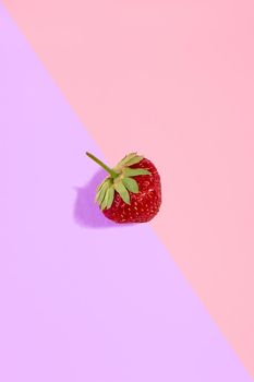 Fresh red strawberry isolated on pink-purple background. Pattern