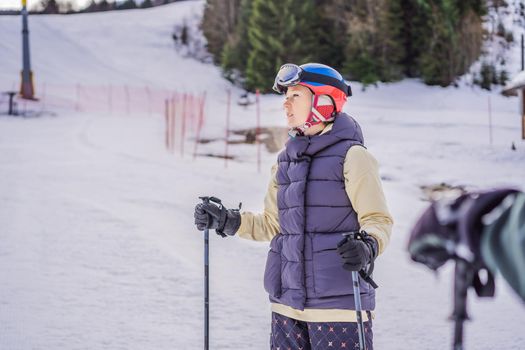 Woman learning to ski. Young woman skiing on a snowy road in the mountains.