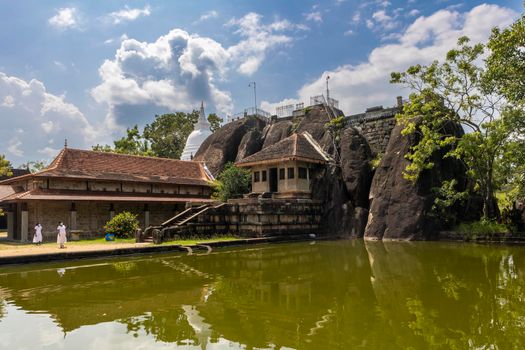 Sri Lanka. Anuradhapura. Isurumuniya Buddhist temple (Isurumuniya Rajamaha Viharaya). A popular attraction. View from the pond on a clear sunny day. High quality photo