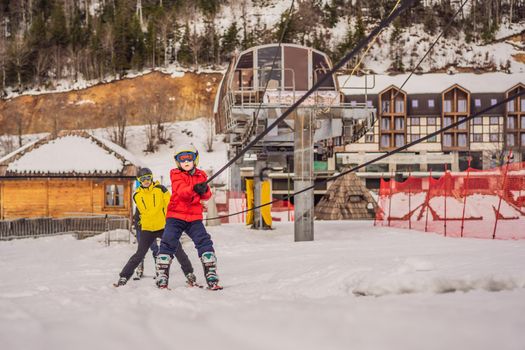 Instructor teaches boy skier to use on ski lift.