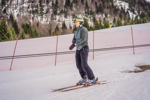 Ski instructor at training track showing students how to ski.