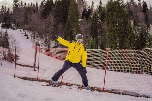 Ski instructor at training track showing students how to ski.