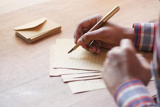 envelope , empty paper and fountain pen on table .
