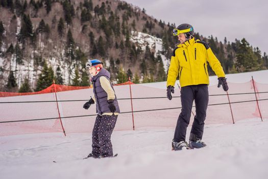 Woman learning to ski with instructor. Winter sport. Ski lesson in alpine school.
