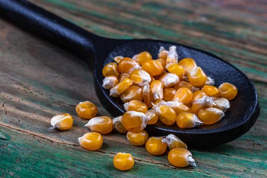 Close-up of corn grains in a wooden spoon