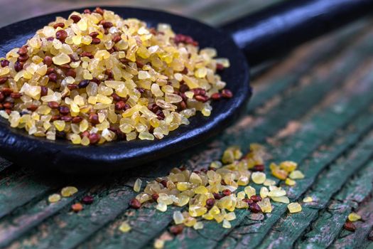 Organic mixing of cereal in macro in a wooden spoon