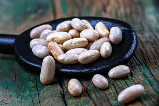 Red beans in close-up in a wooden spoon