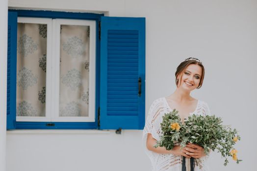 Beautiful wedding couple on a background of white architecture on Santorini island, Greece