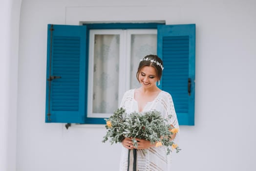 Young attractive bride with the bouquet of flowers.