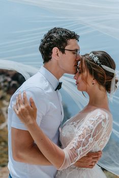 beautiful bride and groom in their summer wedding day on greek island Santorini.