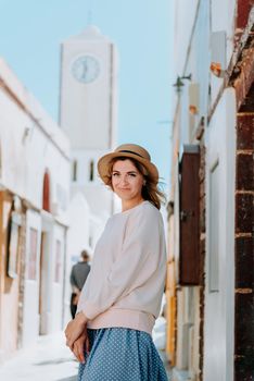 Tourist caucasian girl walking by old town. Boho girl walking on the city street