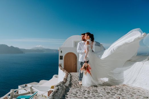 beautiful bride and groom in their summer wedding day on greek island Santorini.