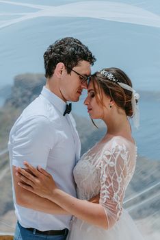 beautiful bride and groom in their summer wedding day on greek island Santorini.
