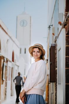 Tourist caucasian girl walking by old town. Boho girl walking on the city street