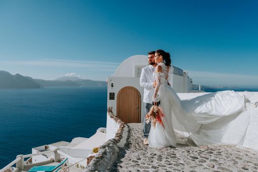 beautiful bride and groom in their summer wedding day on greek island Santorini.