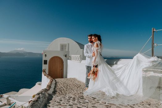 beautiful bride and groom in their summer wedding day on greek island Santorini.