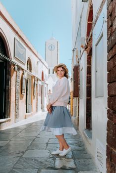 Tourist caucasian girl walking by old town. Boho girl walking on the city street