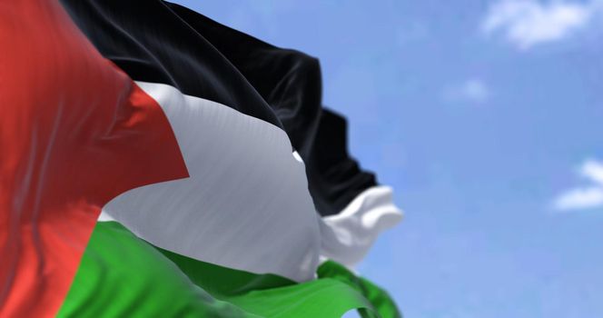 Detail of the national flag of Palestine waving in the wind on a clear day. Democracy and politics. Patriotism. Selective focus.