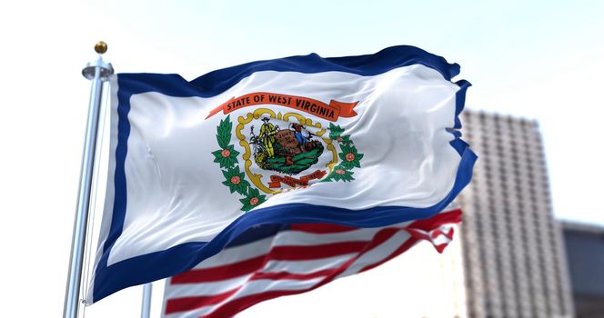 the flag of the US state of New Mexico waving in the wind with the American flag blurred in the background. West Virginia was admitted to the Union on June 20, 1863 as 35th state