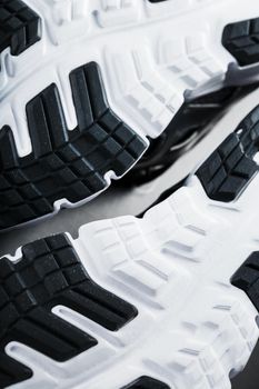 The sole of the sports sneakers for running in black and white close-up. Sports technology