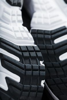 The sole of the sports sneakers for running in black and white close-up. Sports technology