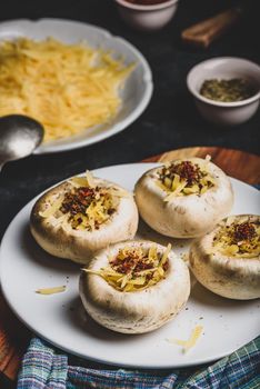 Button mushrooms stuffed with grated cheddar cheese and spices