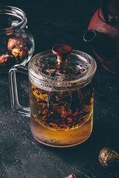 Steeping red tea in glass mug with cap