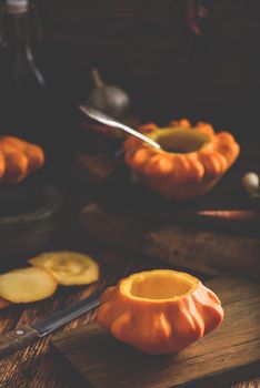 Preparing yellow pattypan squash for stuffing with minced meat