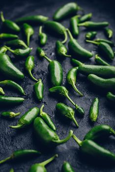 Green Jalapeno Peppers on Dark Concrete Surface