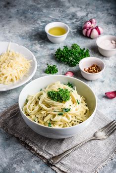 Easy lunch recipe. Linguine pasta with olive oil, garlic, fresh parsley and grated parmesan cheese.