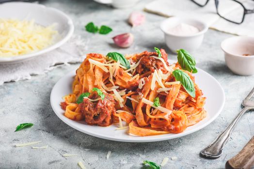 Pasta with mini meatballs, tomato sauce and parmesan cheese